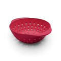 The Mini Berry Colander is a red plastic colander with round holes and two handles, ideal for washing fruit or draining pasta and vegetables. Shown on a white background.