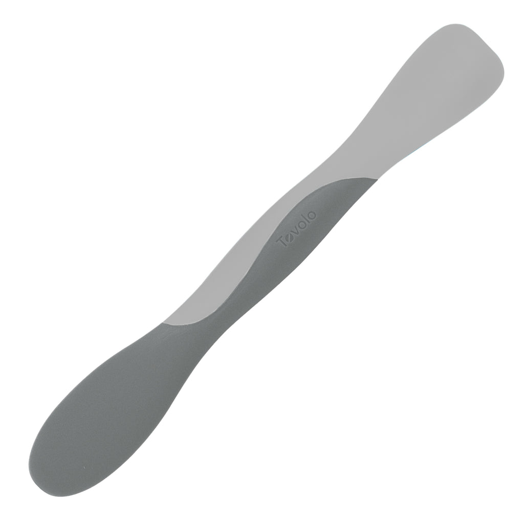 The Scoop and Spread is a double-ended gray silicone spatula with one rounded end for scooping and one flat end for spreading, making it perfect for baking. The Tovolo brand name is embossed in the center of the handle.