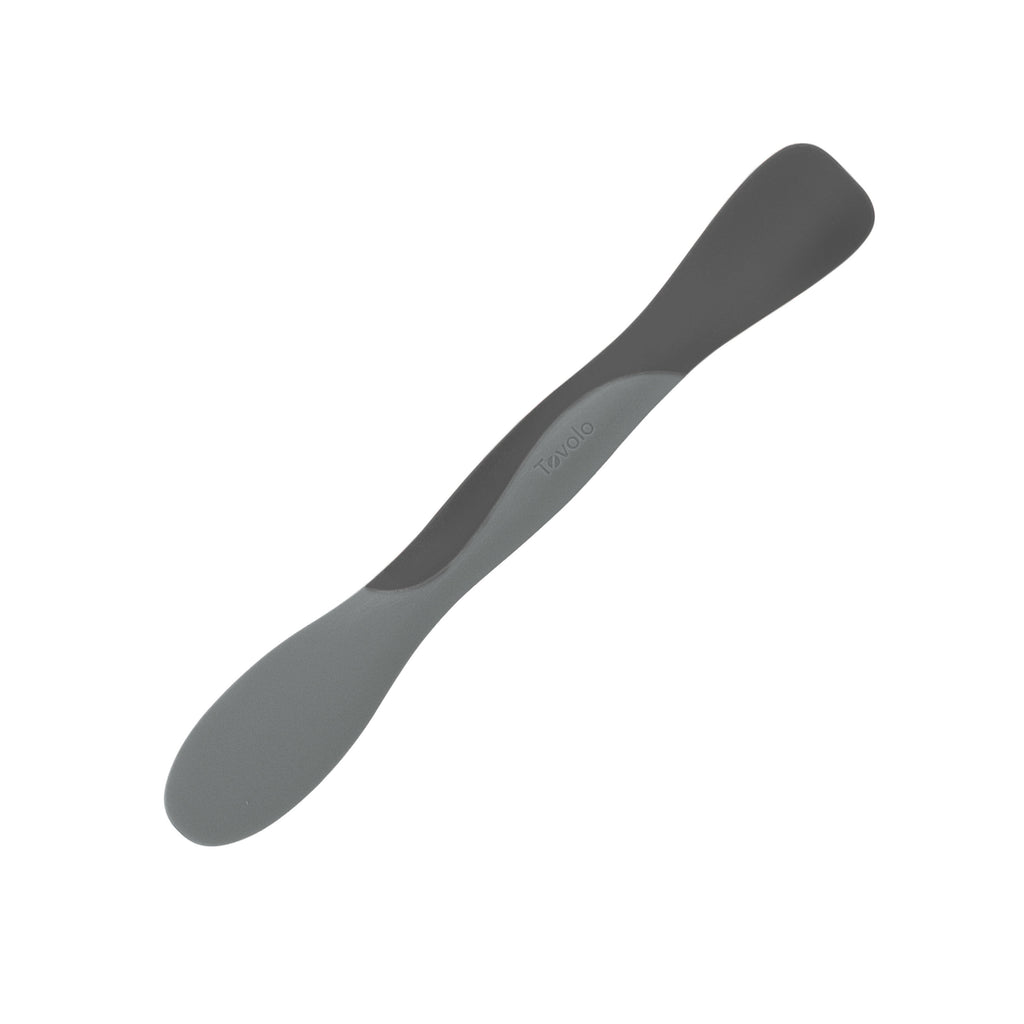 The Scoop and Spread is a double-ended silicone kitchen tool with light and dark gray ends, perfect for scooping and spreading ingredients—making it a sleek, modern essential for every baker.