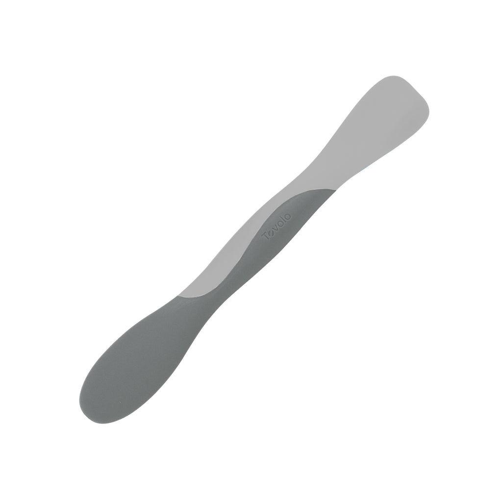 The Scoop and Spread is a double-ended gray silicone spatula with a flat edge and a rounded edge, perfect for scooping, mixing, and spreading—an essential tool for any baker.