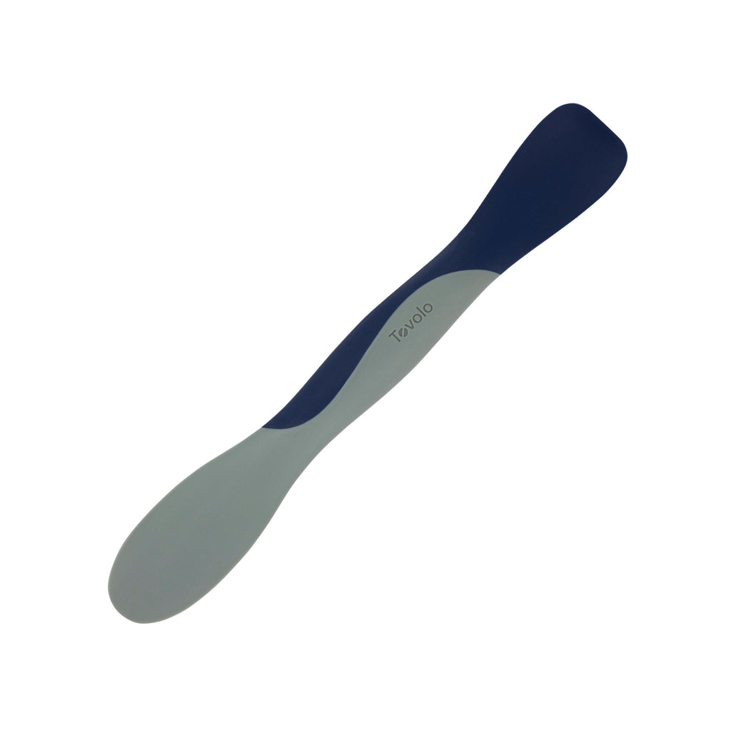 The Scoop and Spread is a dual-ended kitchen tool with blue and gray ends and a curved design for scooping and spreading; “Tovolo” is printed on the handle, making it a baker’s best friend.