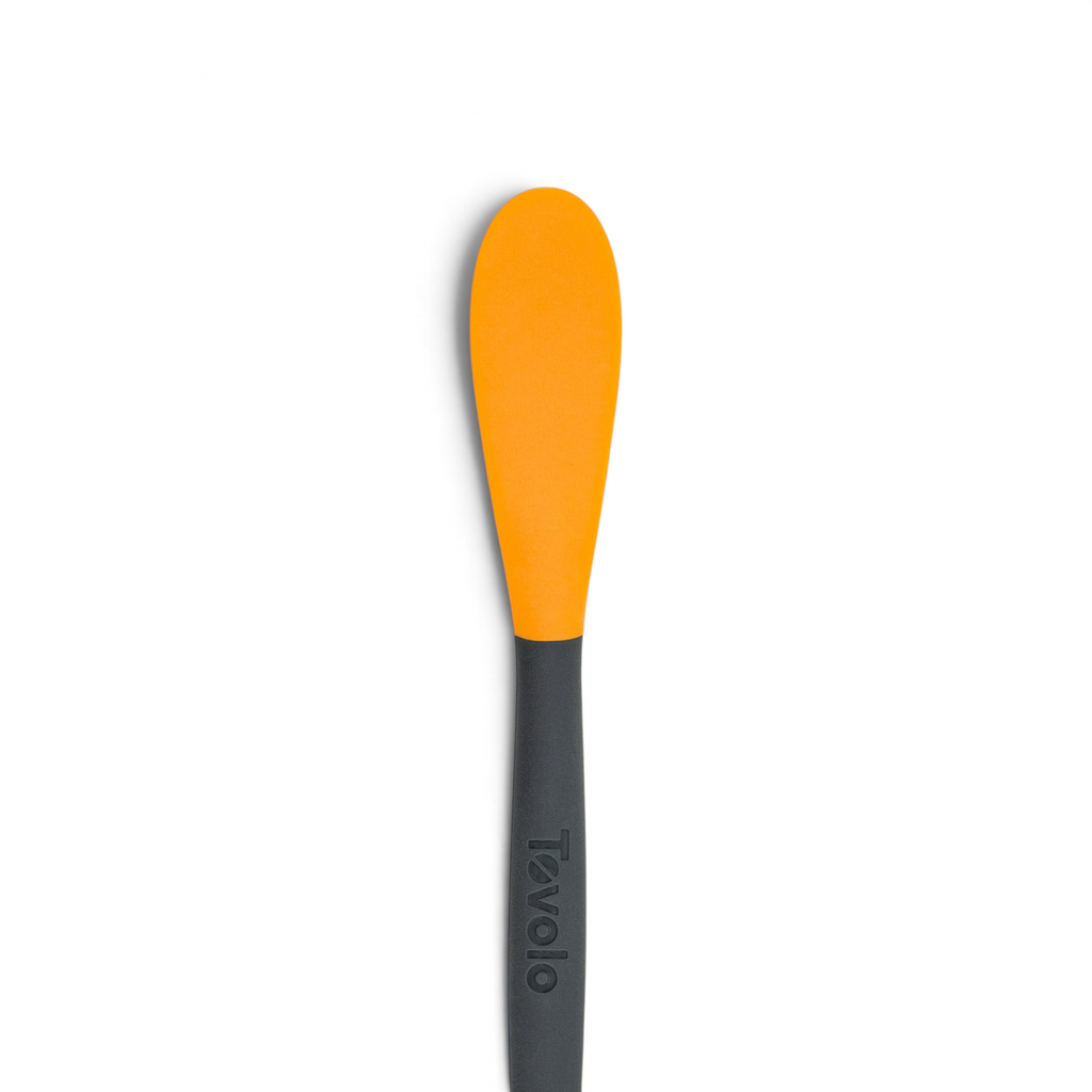 The 2-in-1 Slice and Peel Citrus Tool, featuring an orange flexible head and black handle with the Tovolo brand name, is displayed against a white background—a handy addition to your kitchen.
