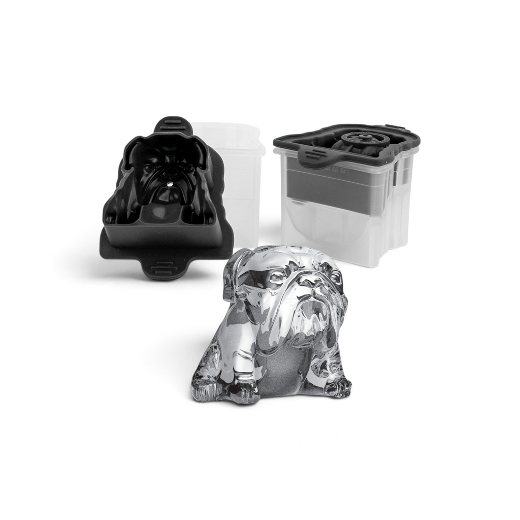 A lifelike bulldog ice cube is displayed with a tovolo Dog Ice Molds (Set of 2) in black silicone and a clear plastic container, both designed to create detailed dog-shaped ice cubes.