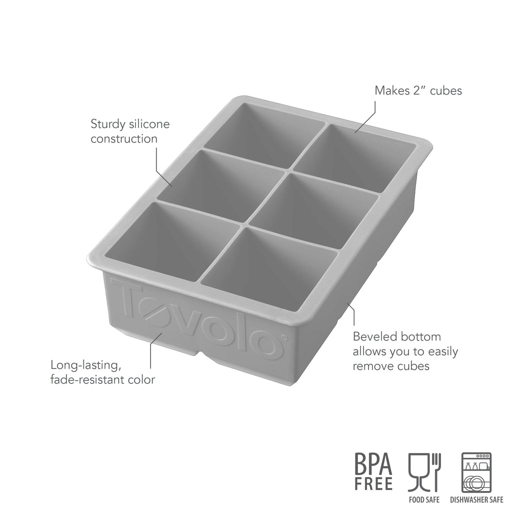 The tovolo King Cube Silicone Ice Mold features sturdy silicone construction, long-lasting color, and a beveled bottom for easy 2-inch cube removal. BPA free, food safe, and dishwasher safe icons included. Six compartments.