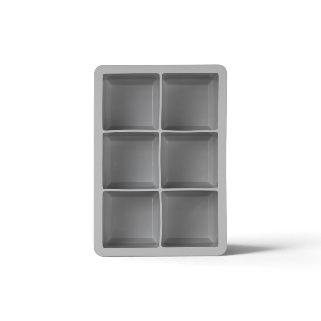 The tovolo King Cube Silicone Ice Mold features six rectangular cavities in two columns and three rows, ideal for making large, slow-melting cubes for cocktails. Shown here from a top-down view.
