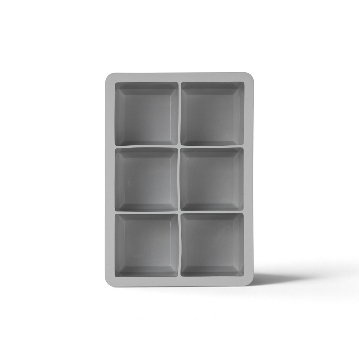 The tovolo King Cube Silicone Ice Mold features six rectangular cavities in two columns and three rows, ideal for making large, slow-melting cubes for cocktails. Shown here from a top-down view.