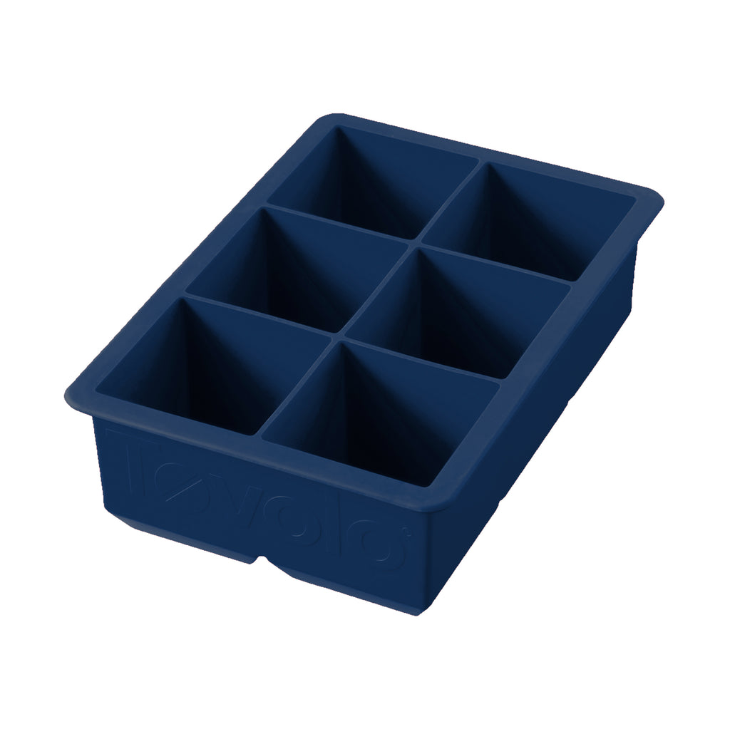 The King Cube Ice Mold is a dark blue silicone tray with six large rectangular compartments, ideal for crafting oversized ice cubes.