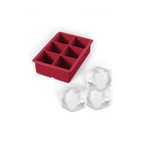 The tovolo King Cube Silicone Ice Mold features six large compartments and is shown with three clear craft ice cubes—ideal for creating impressive drinks with this durable, red ice cube tray.