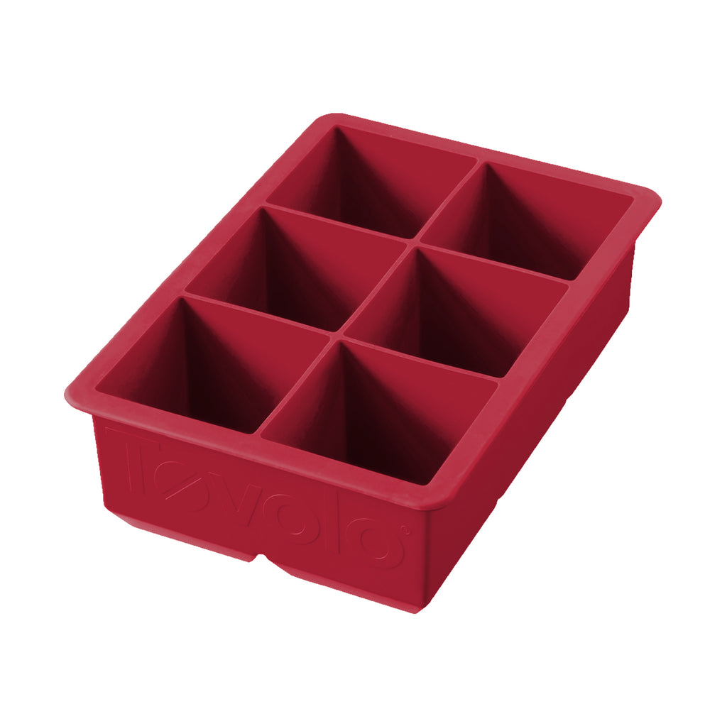 The tovolo King Cube Silicone Ice Mold features six large rectangular compartments, ideal for making extra-large ice cubes for cocktails and drinks.