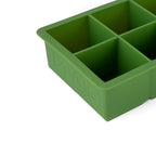The tovolo King Cube Silicone Ice Mold features four large compartments for craft ice and a raised tovolo logo on the side. Perfect for making large ice cubes.