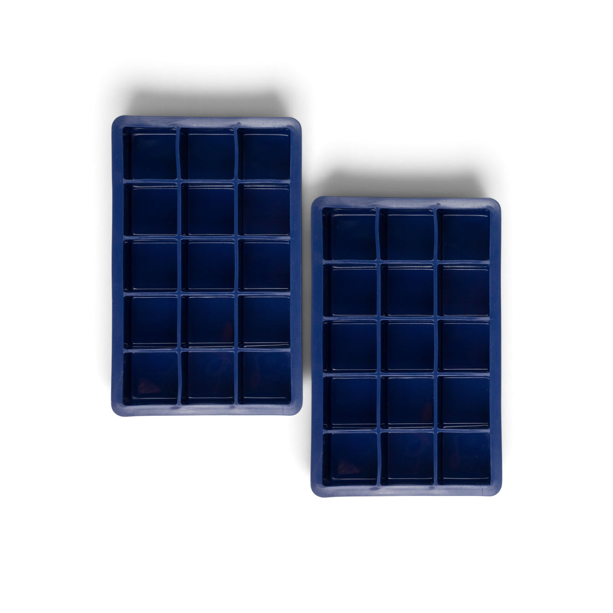 The tovolo Perfect Cube Silicone Ice Molds (Set of 2) are blue, rectangular trays made from food-grade silicone, ideal for crafting long-lasting ice cubes.