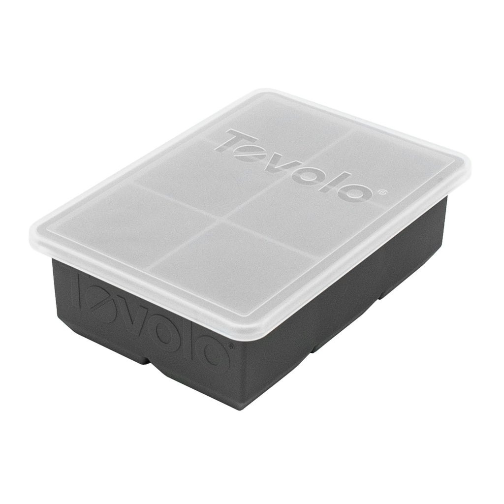 The Tovolo King Cube Ice Mold is a black silicone tray with a clear plastic lid, both branded with the Tovolo logo. Its rectangular design creates large square ice cubes.