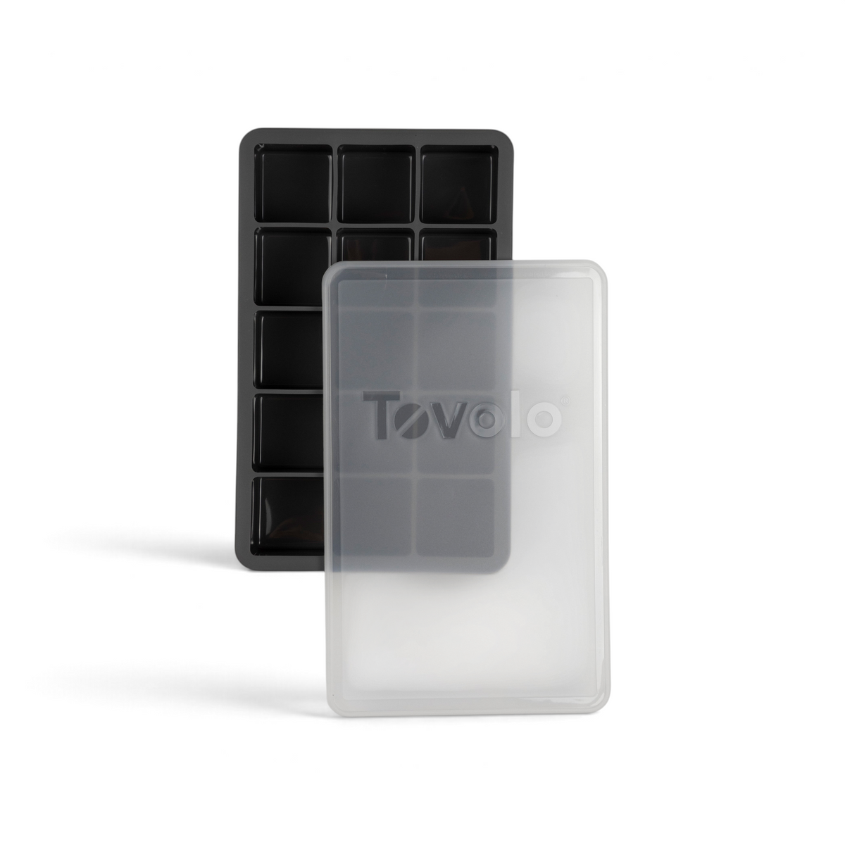 The tovolo Perfect Cube Silicone Ice Mold, shown in black with ten rectangular compartments, is displayed beside a translucent plastic lid marked with the tovolo logo.