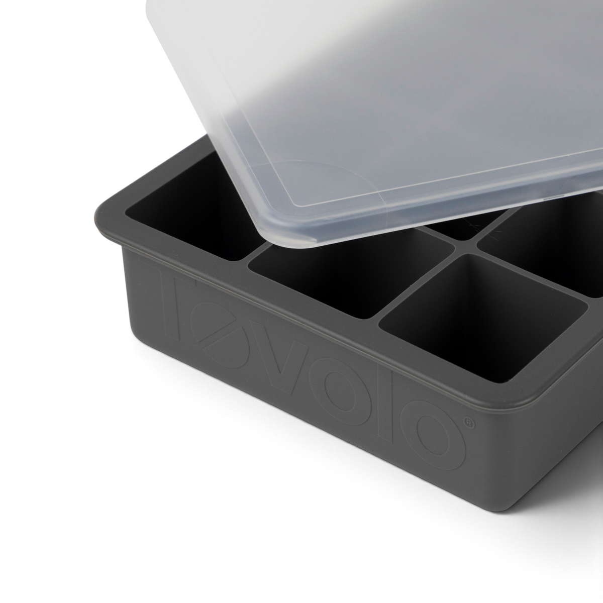 The tovolo Perfect Cube Silicone Ice Mold is a black food-grade tray with six large square compartments and a transparent plastic lid, partially open, showing "tovolo" embossed on the side.