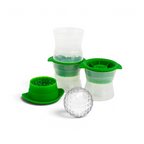 Two tovolo Baseball Ice Molds with flexible sides and textured lids sit beside a large, clear baseball-shaped ice sphere. The stackable molds are green and clear.