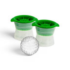 Two green and white tovolo Baseball Ice Molds (Set of 2) are shown behind a large, round ice sphere shaped like a baseball with seams, all placed on a white surface.