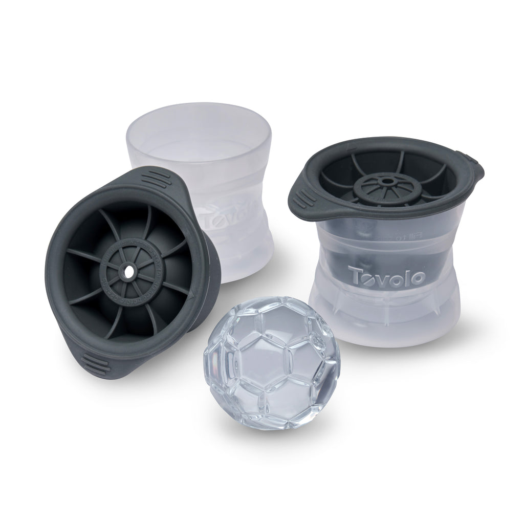 Three clear, stackable Sports Ice Molds with black lids are shown; one is upright, another displays the interior, and the third is stacked with its lid on, alongside a soccer ball-shaped ice sphere.