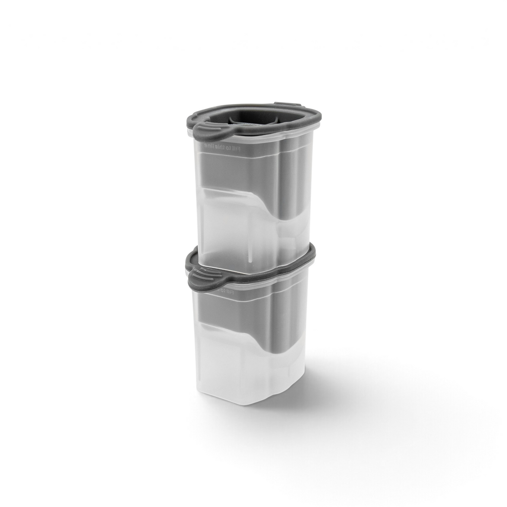 Two clear Dog Ice Molds (Set of 2) by tovolo, with gray lids, are stacked securely. Their modern rectangular design is great for organizing kitchen tools, especially silicone molds for making fun craft ice.