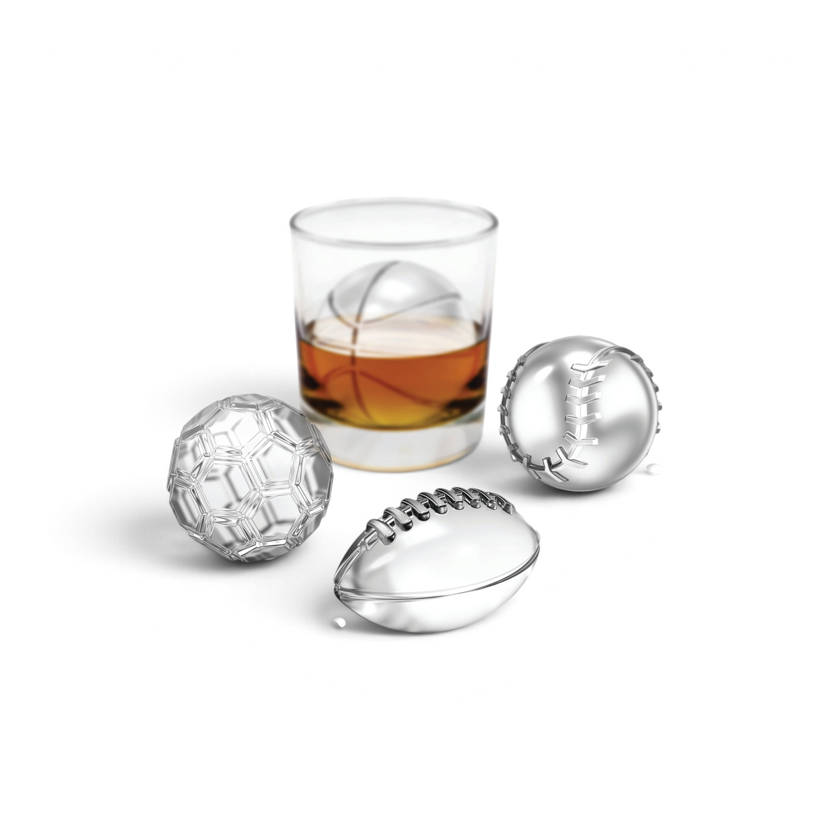 Showcased are two tovolo Baseball Ice Molds beside a glass of whiskey featuring a baseball-shaped ice mold. These stackable molds offer fans a unique way to chill drinks. White background.