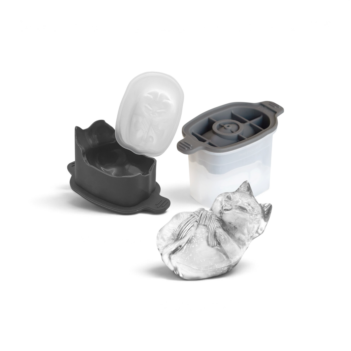 A tovolo Dog Ice Mold and its lid, shown open, with a detailed dog-shaped ice cube lying in front. Perfect for craft ice enthusiasts, the set of two molds forms a dog lying down with its paws together.