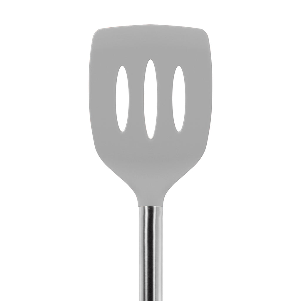 The Silicone Slotted Turner features a gray silicone head with three oval slots, a stainless steel handle, and is safe for nonstick cookware. Shown against a white background.