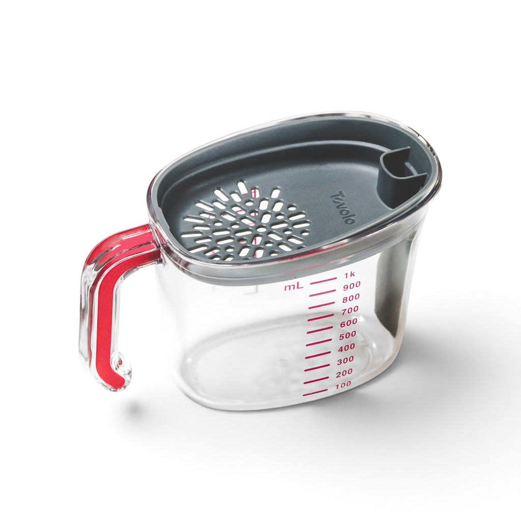The Gravy Strainer is a clear plastic measuring cup with a red handle, gray silicone strainer lid, red markings up to 1000 mL. The cup is empty and shown isolated on a white background.