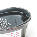 A close-up of the Gravy Strainer shows its clear cup with milliliter markings, a gray plastic lid with a built-in strainer, and a pour spout, perfect for separating fat when making gravy.