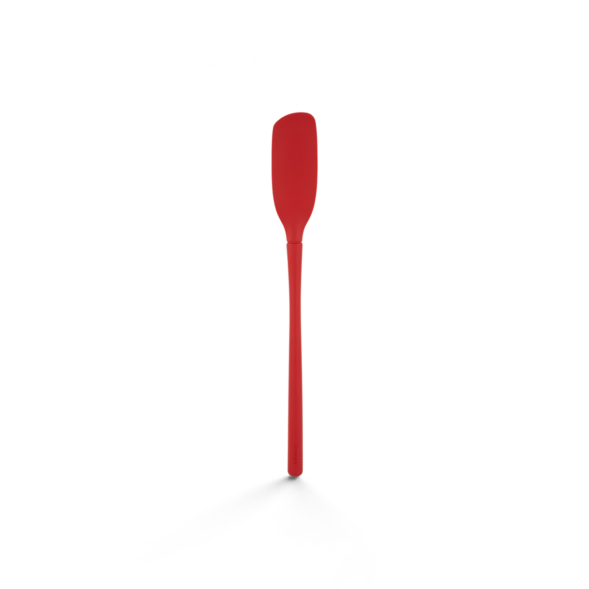 The Flex-Core Blender Spatula is a long, narrow red silicone spatula with a slightly curved blade and a straight handle, shown on a white background.