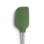 The Flex-Core Spatula features a green silicone rounded rectangular head and a stainless steel handle, designed for durability and shown against a white background.