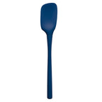 The Flex-Core Spoonula is a blue silicone spatula featuring a long handle and wide, slightly curved blade, ergonomically designed for the kitchen and shown against a white background.