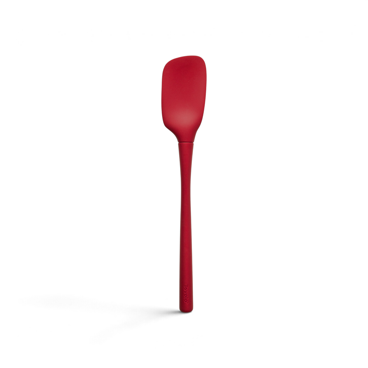 The tovolo Flex-Core Silicone Spoonula, shown against a white background, features a long handle and slightly curved red rectangular blade, offering the versatile function of a spatula spoon with everyday durability.