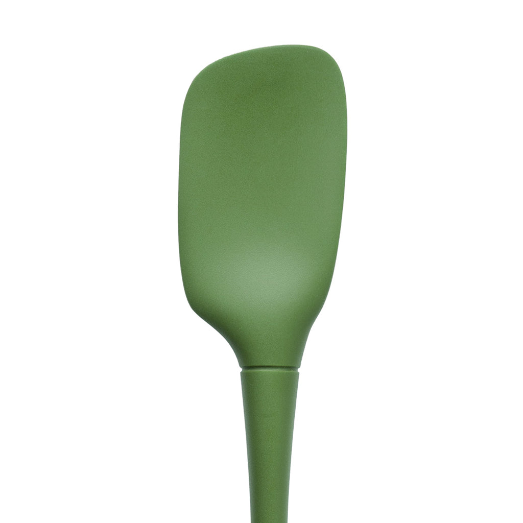 The tovolo Flex-Core Silicone Spoonula, in green, features a wide, slightly curved blade and a tapered handle, displayed against a white background.