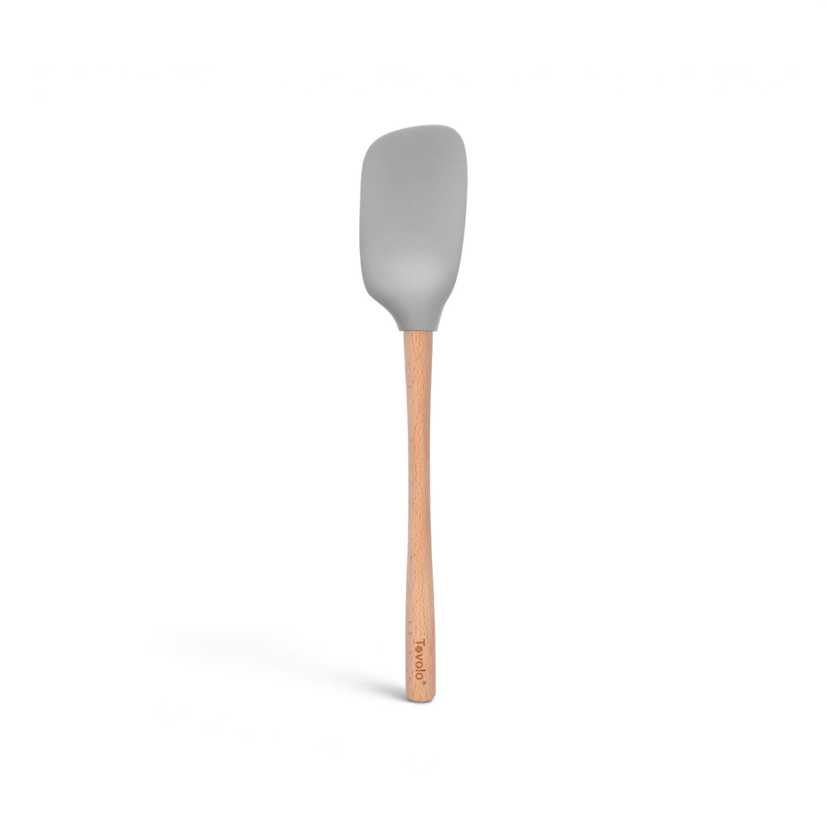 The tovolo Flex-Core Silicone Spoonula, shown against a white background, features a gray rounded rectangular silicone head and a long wooden handle.