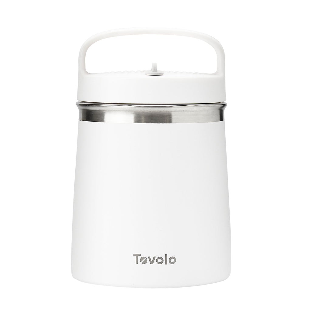 The Insulated Food Traveler is a white food flask with a top handle, stainless steel band around the lid, and Tovolo branding on the front, providing spill-proof travel convenience.