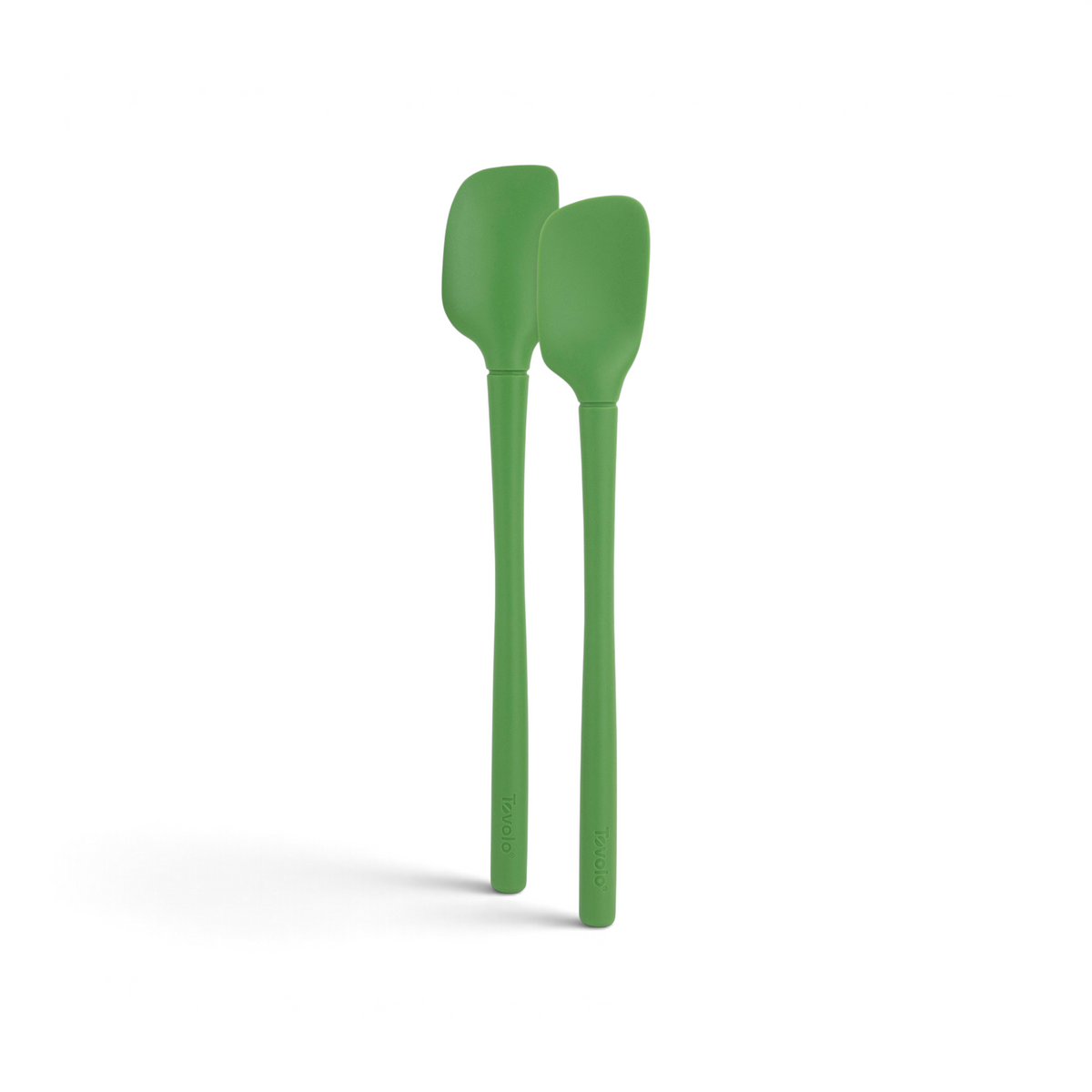 The tovolo Flex-Core Silicone Mini Spatula + Spoonula set features two green, heat-resistant utensils with long handles, standing upright side by side on a white background—perfect for versatile kitchen tasks.