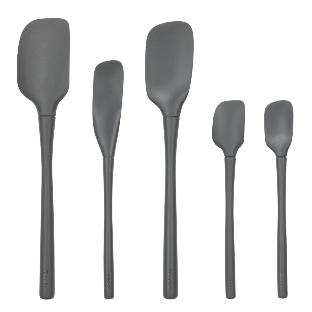 Five black tovolo Flex-Core All-Silicone Spatula Set of 5 pieces, including a classic spatula and jar scraper, stand upright in a row against a white background for versatile kitchen use.