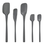 Five black tovolo Flex-Core All-Silicone Spatula Set of 5 pieces, including a classic spatula and jar scraper, stand upright in a row against a white background for versatile kitchen use.