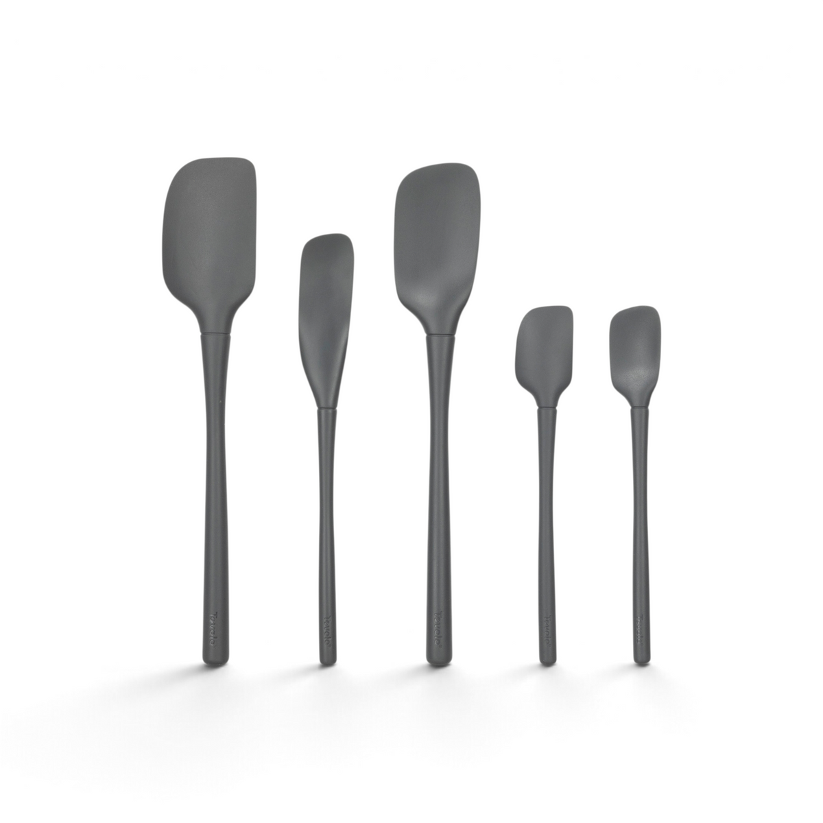 Five black tovolo Flex-Core All-Silicone Spatula Set of 5 pieces, including a classic spatula and jar scraper, stand upright in a row against a white background for versatile kitchen use.