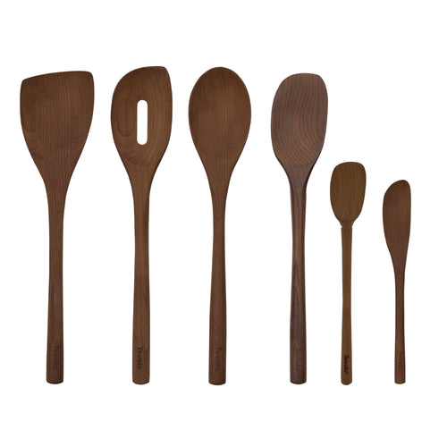 The Beechwood Utensils set features six wooden kitchen tools—spoons, spatulas, a pancake turner, and a slotted spoon—arranged upright in a row against a white background, perfect for use with non-stick cookware.