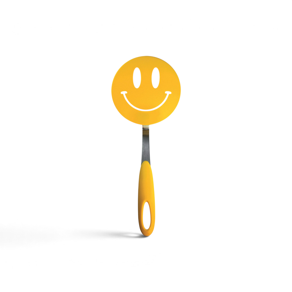 The Spatulart Flex Turner is a yellow nylon spatula with a handle and a round, flexible head featuring a smiling face cut-out—ideal for nonstick skillets.
