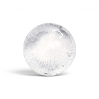 A clear, round ice sphere with intricate cracks and air bubbles made using tovolo Sphere Ice Molds (Set of 2), set against a white background.