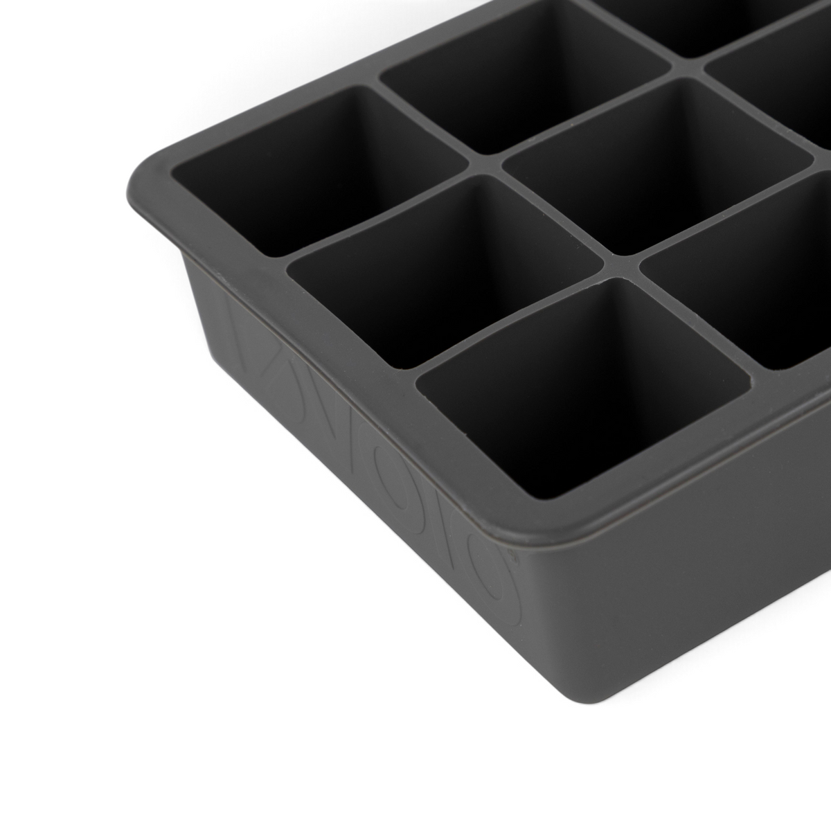 A close-up of tovolo Perfect Cube Silicone Ice Molds (Set of 2) shows large square compartments from the top and side—ideal for making long-lasting ice cubes.