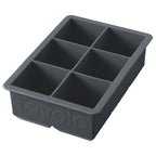 The King Cube Ice Mold is a black silicone tray with six large rectangular compartments, ideal for making big ice cubes. "Tovolo" is embossed on the side, making it a premium craft ice tray for any kitchen.