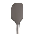 The Flex-Core Spatula, featuring a gray silicone head and stainless steel handle, is displayed against a white background.