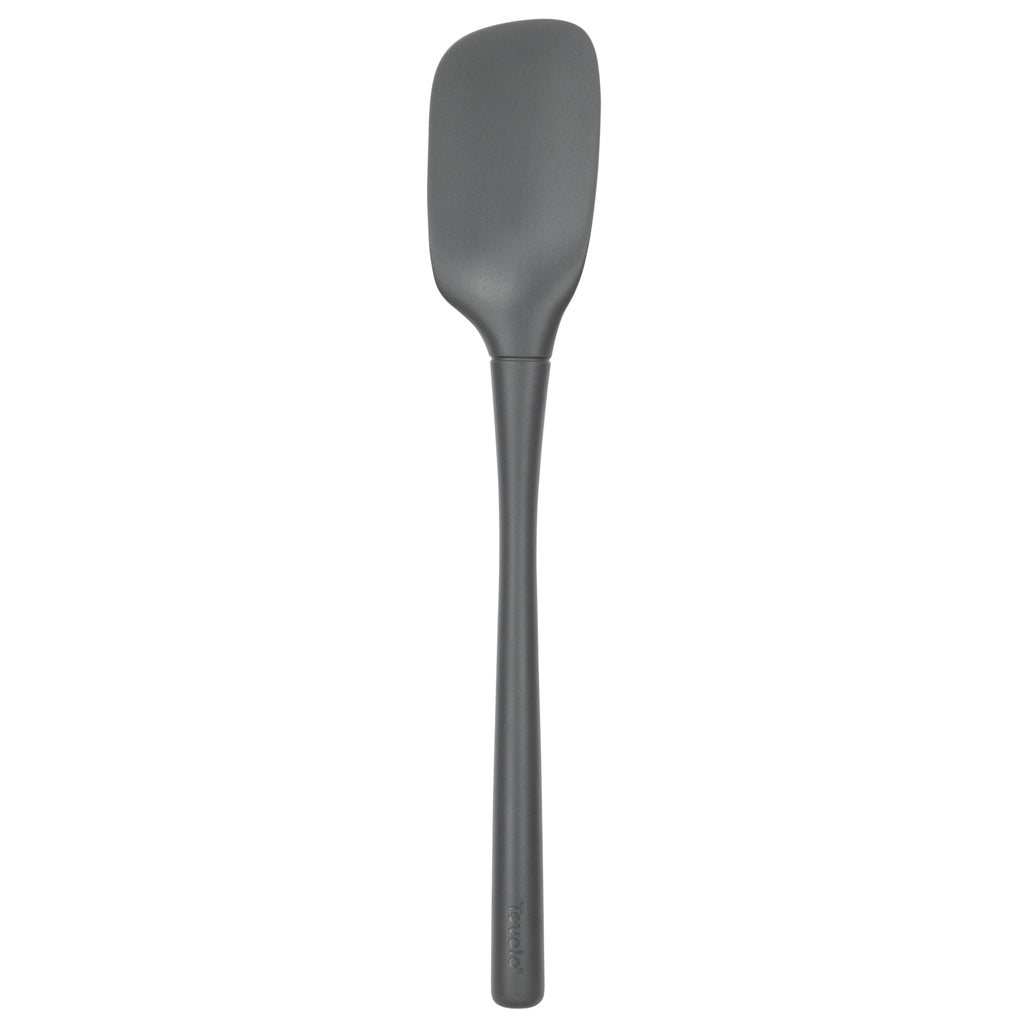 The Flex-Core Spoonula, shown in gray with a long handle and flat, flexible rectangular head, is an ergonomic silicone kitchen tool ideal for any cooking task, pictured against a plain white background.