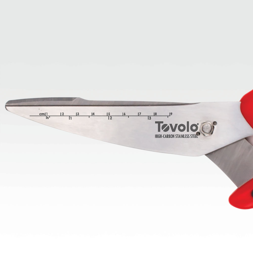 Close-up of Kitchen Shears with ergonomic handles, a stainless steel blade featuring built-in cm and inch rulers, and a vibrant red handle on the right.