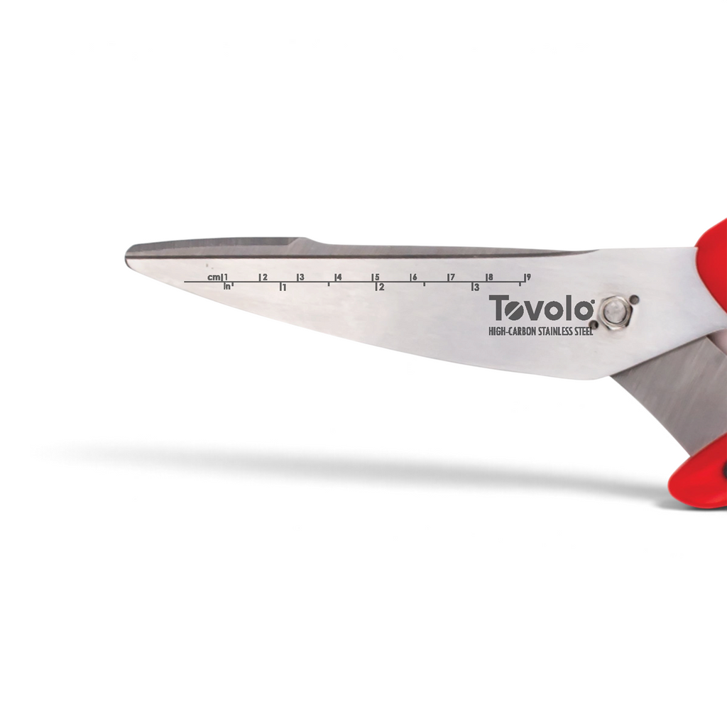 Close-up of Kitchen Shears with ergonomic handles, a stainless steel blade featuring built-in cm and inch rulers, and a vibrant red handle on the right.