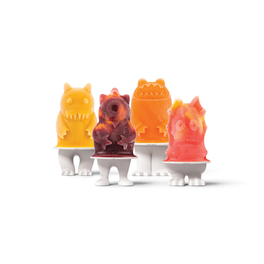 Four vibrant homemade frozen treats shaped like playful monsters stand in Pop Molds with footed bases. Each monster pop—yellow, orange, red, and purple—features unique details, adding fun to frozen snacks.