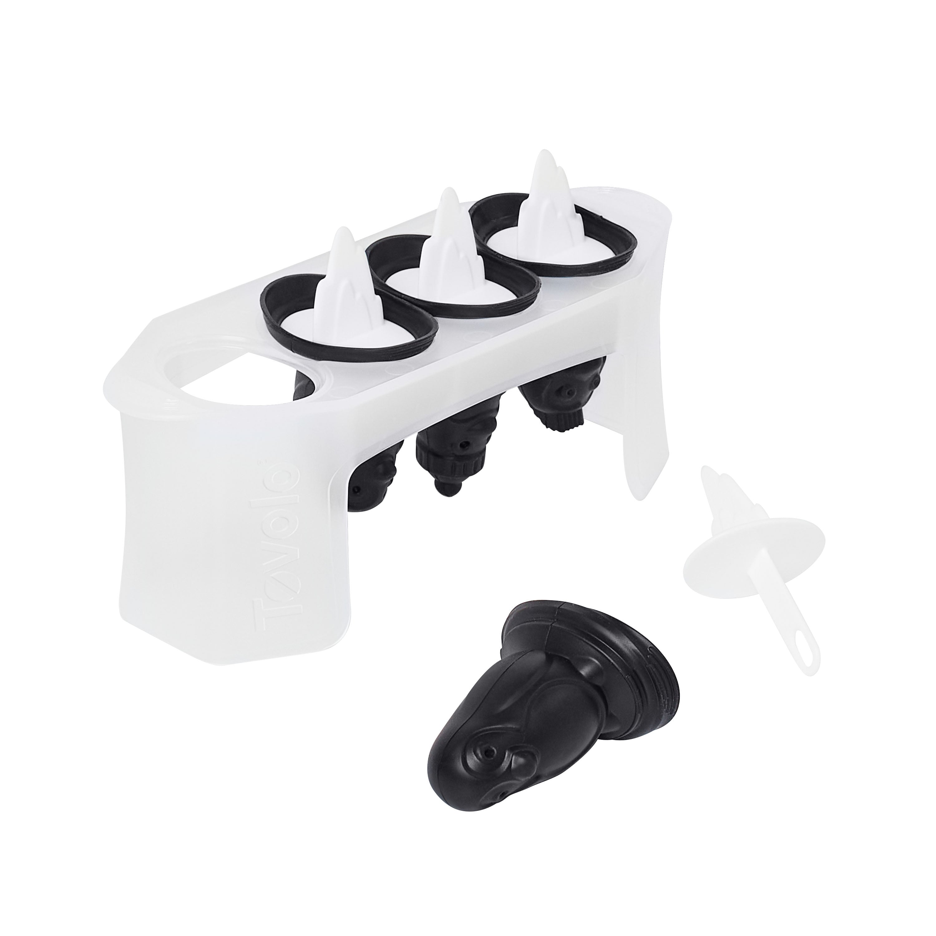 The Penguin Pop Molds set features a slimline tray holding four black and white molds shaped like penguins, with one mold removed and its white stick beside it—ideal for crafting homemade frozen treats.