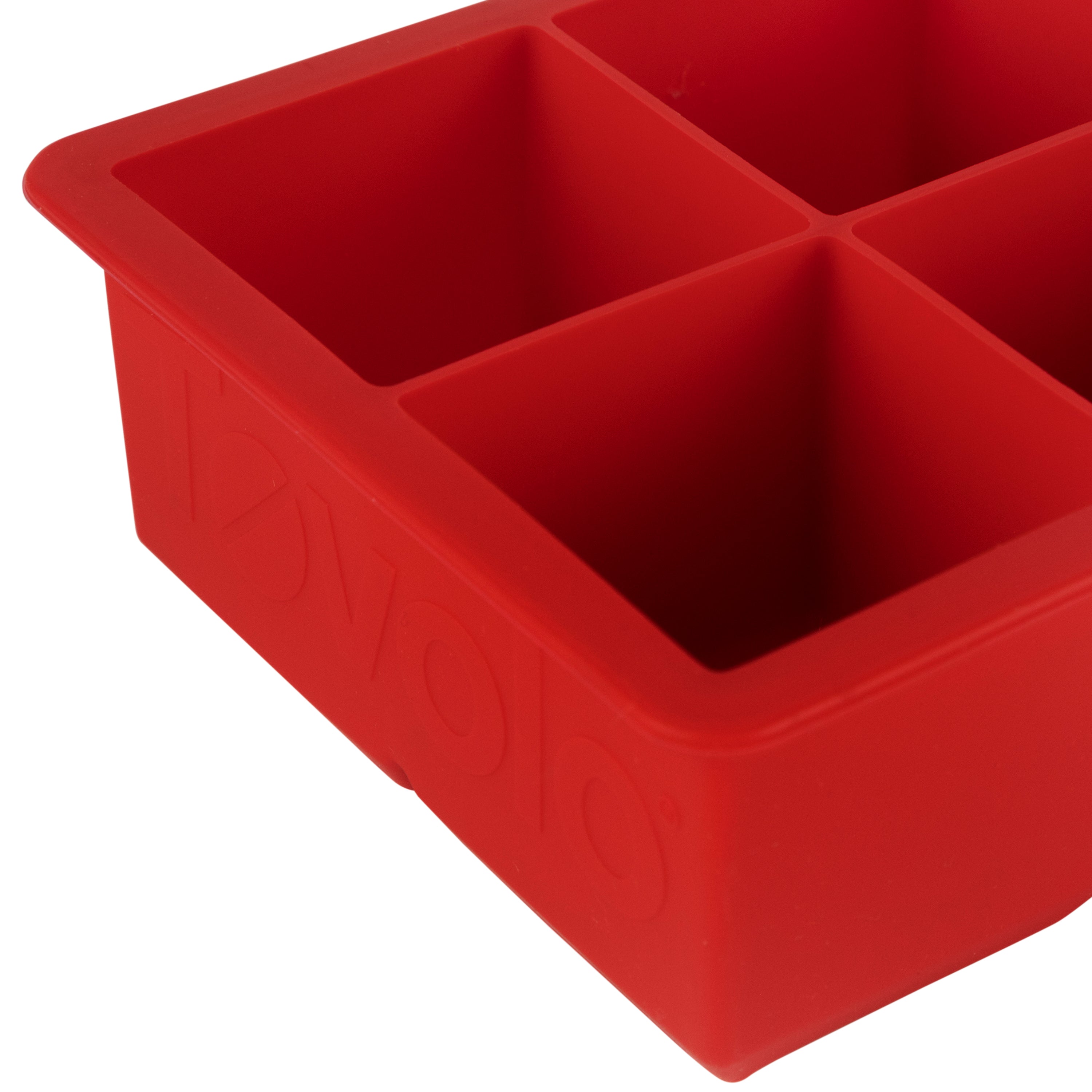 A close-up of the tovolo King Cube Silicone Ice Molds (Set of 2), featuring four large square compartments for craft ice or oversized cubes, shown from an angle.